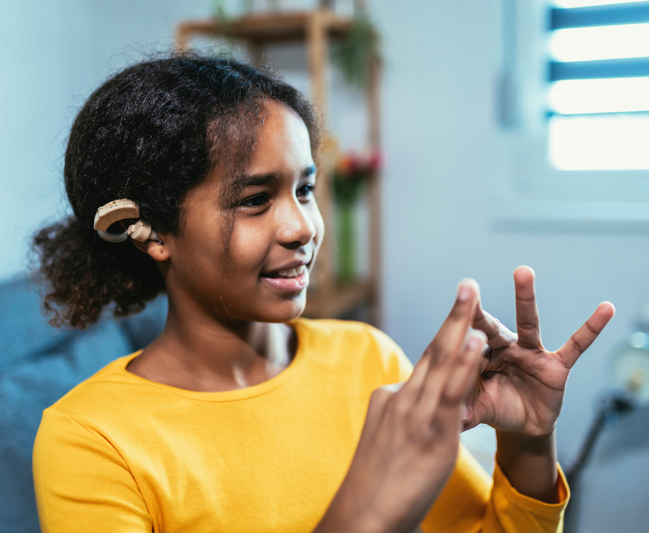 Young girl using American Sign Language